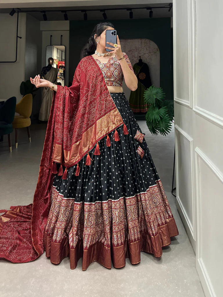 BLACK COLOR BANDHANI AND AJRAKH PRINT WITH FOIL WORK DOLA SILK CHANIYA CHOLI